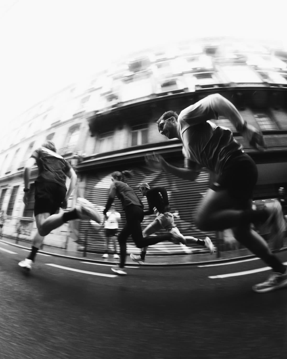 Group of runners in motion through the city